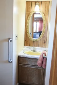 Small basin with mirror and towel stand