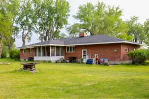 House with large lawn and trees