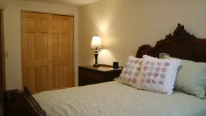 Bedroom with side table with lamp and cupboard