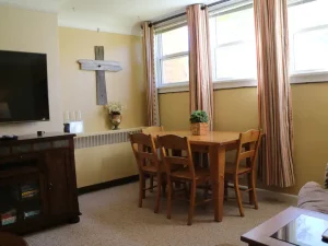 TV Lounge with dining table cross on the wall