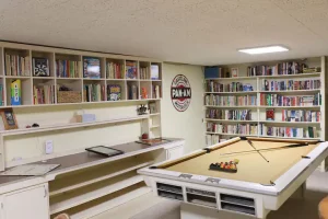 Pool in a room with book shelf