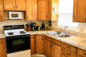 kitchen with cabinets, oven sink, and stove with cooking range