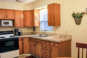 A kitchen with a table and chairs.