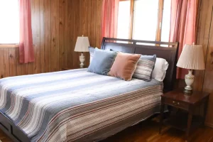 bed room with cushions and side table lamps