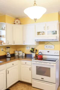 Kitchen with white cabinets showing cooking range