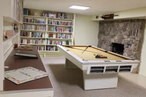 Room with snooker table and book shelves