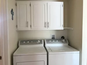 White washing machine and white cabinets